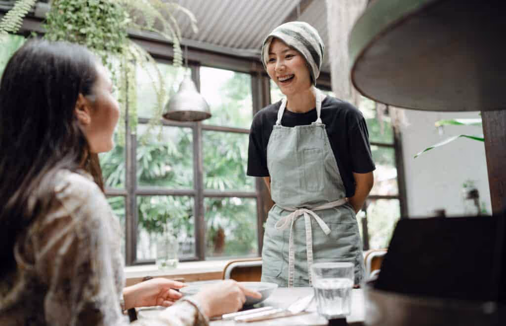 Barista smiling at customer.