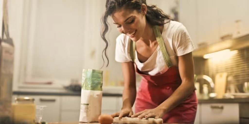 An employee cooking for recipe round-up team building activity.
