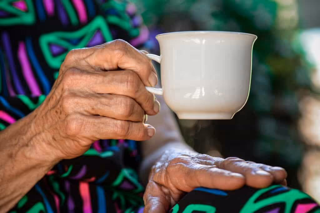 A care home patient drinking tea.