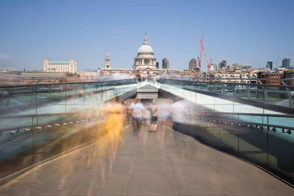 Sped up image of people walking fast towards public transport.