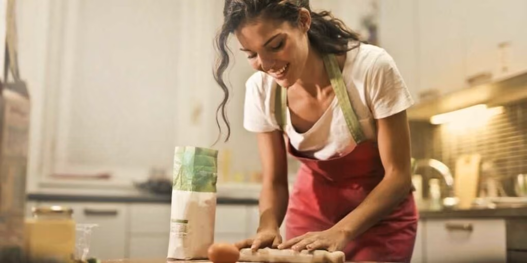 An employee cooking for recipe round-up team building activity.