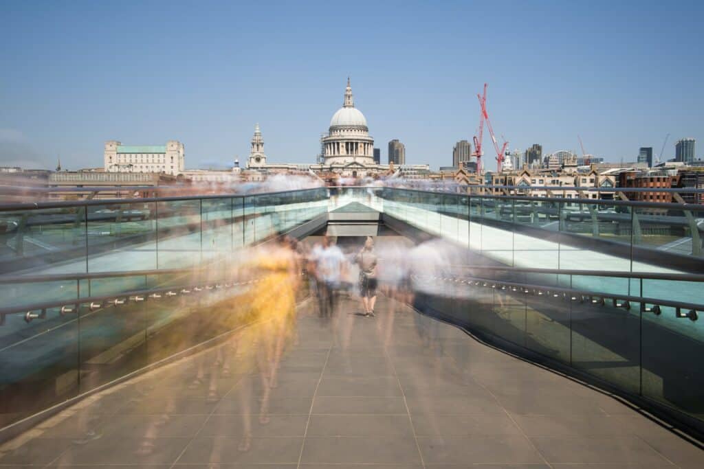 Sped up image of people walking fast towards public transport.