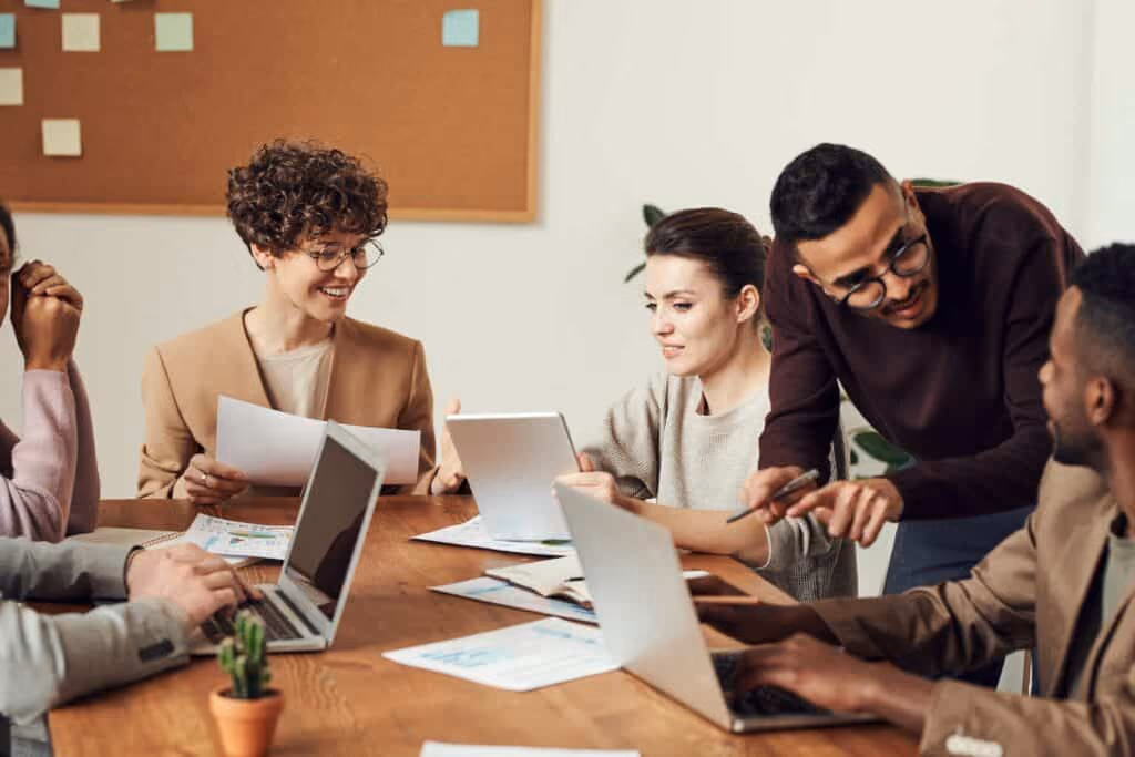 Group of employees in an office doing employee engagement activities. 