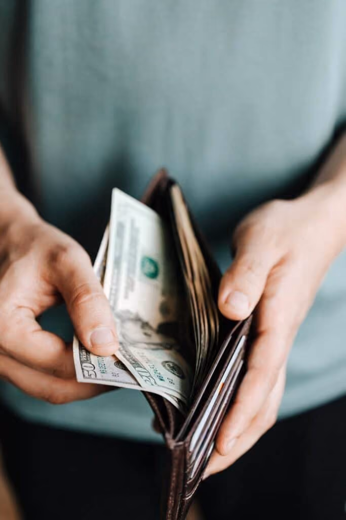 Open wallet with cash inside.