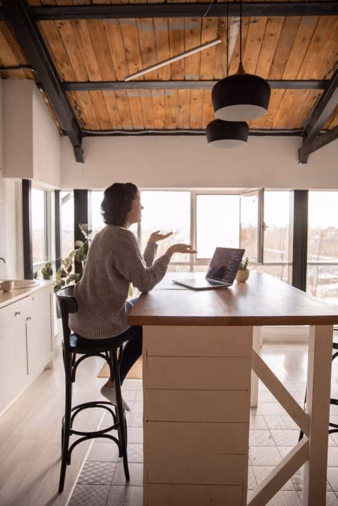 Woman in front of laptop explaining.