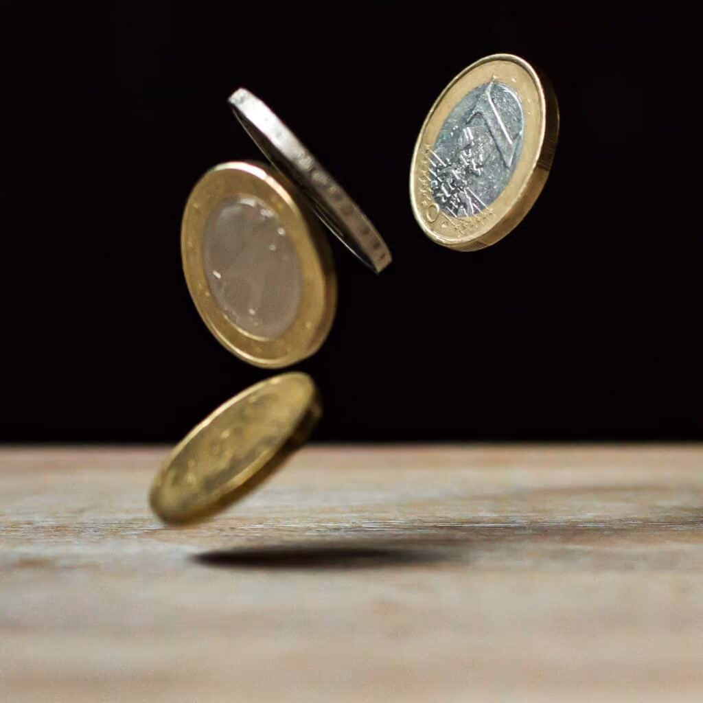Euros falling onto table.
