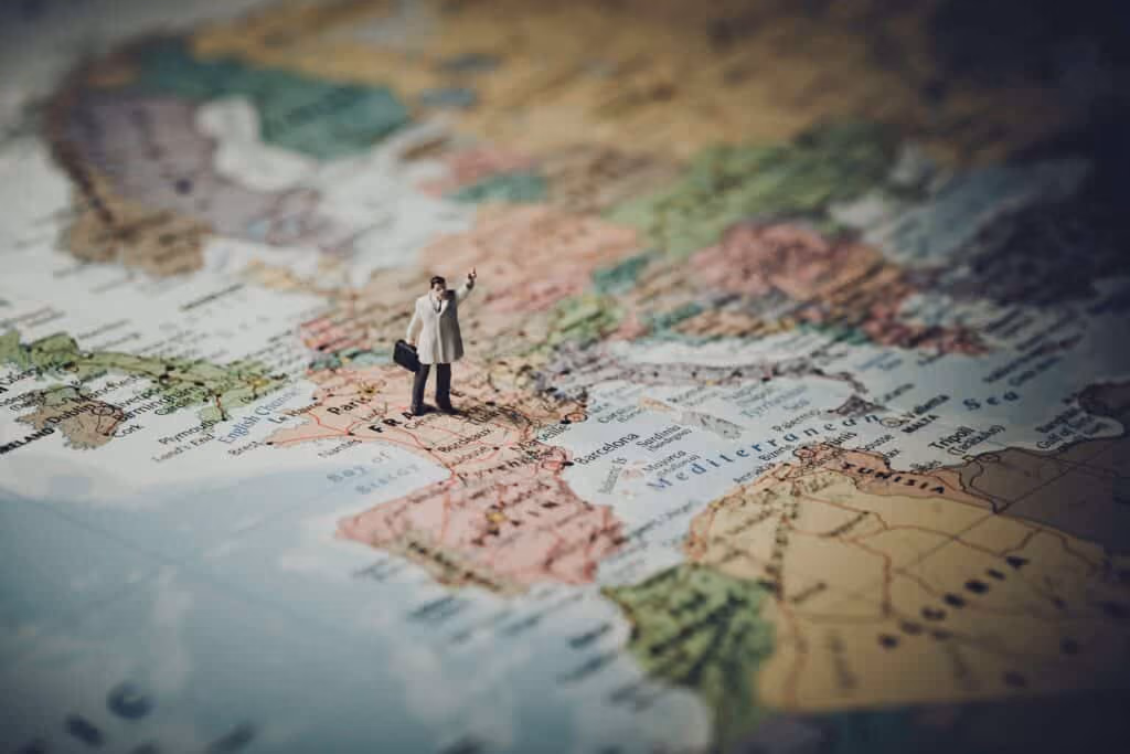 Model of businessman on map.