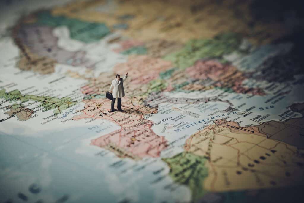Model of businessman on map.