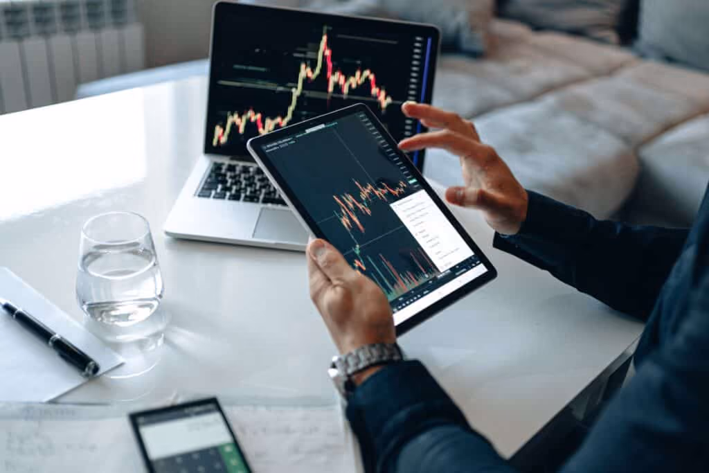 iPad and Laptop with technical charts on screen.