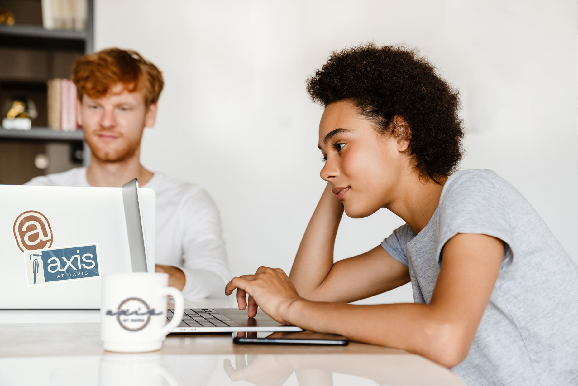 two students studying looking at a laptop