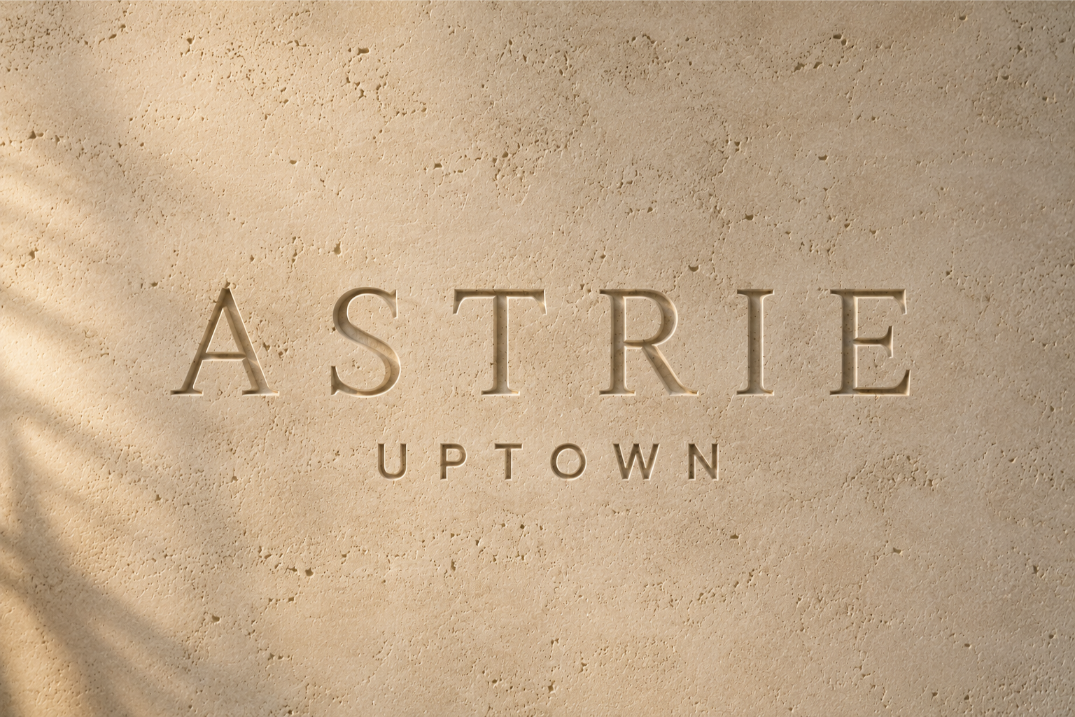 primary logo for the astrie projected onto a shadowed, travertine wall