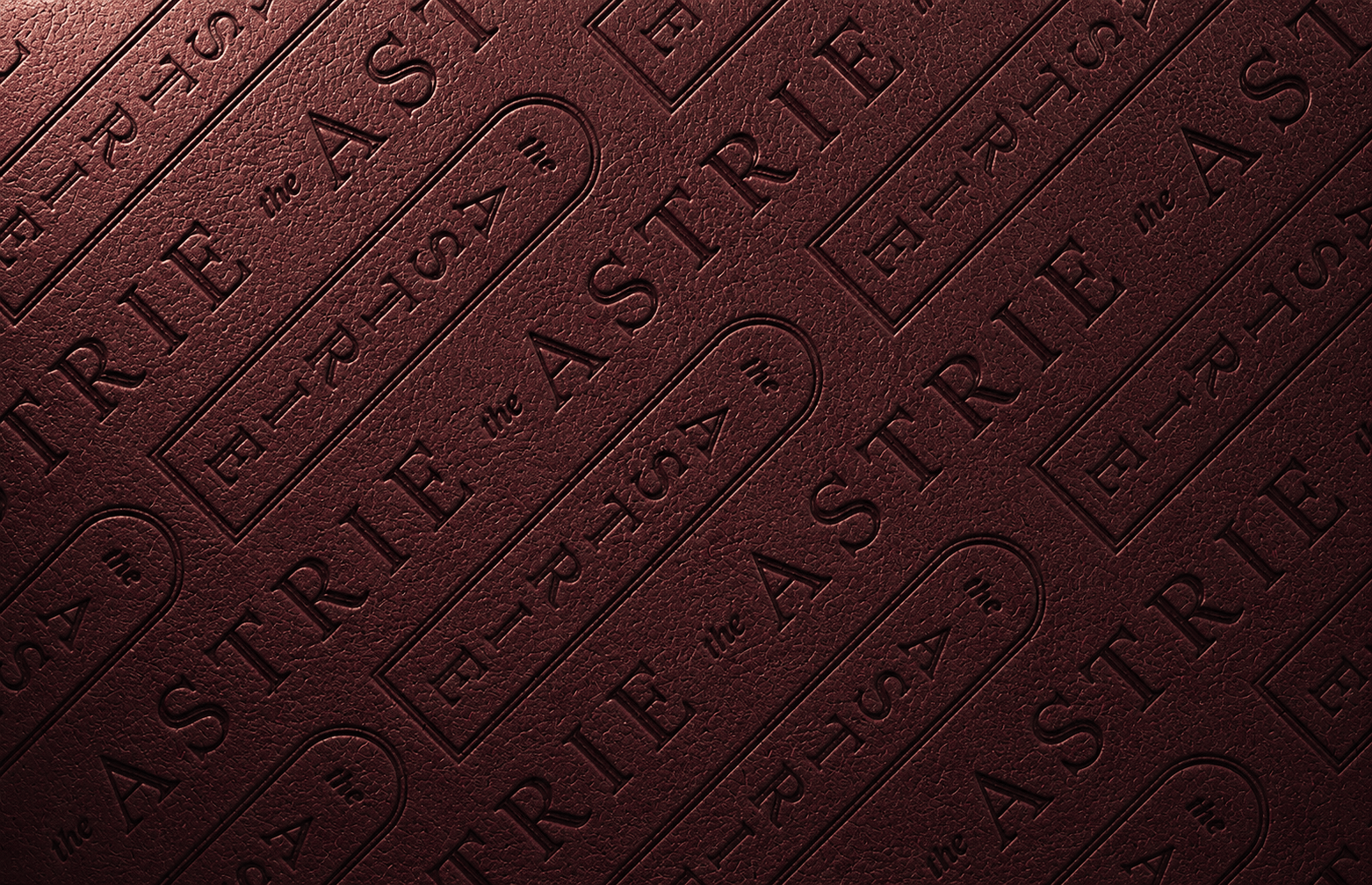 the astrie logo embossed on a red colored leather mockup