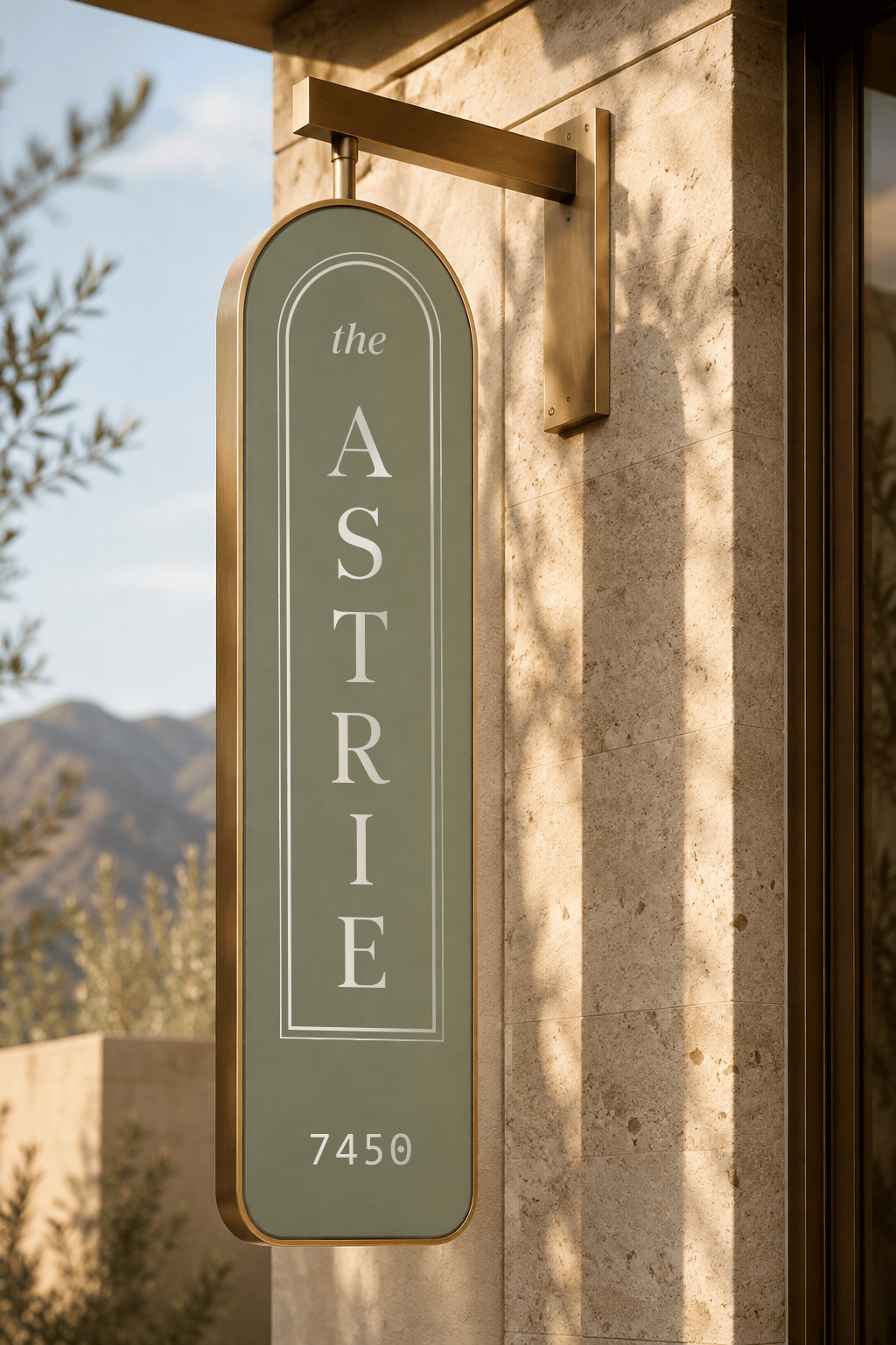 a green arched sign design with the astrie logo on the exterior of a building