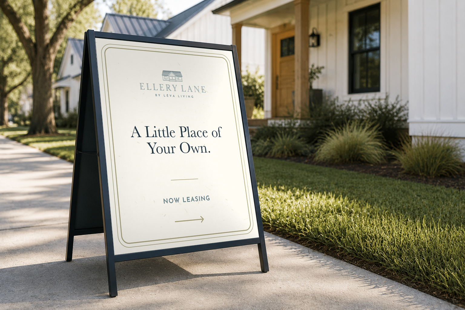 Ellery Lane sidewalk A-frame sign featuring “A Little Place of Your Own.” and “Now Leasing,” positioned along a landscaped walkway in front of white cottage-style homes.