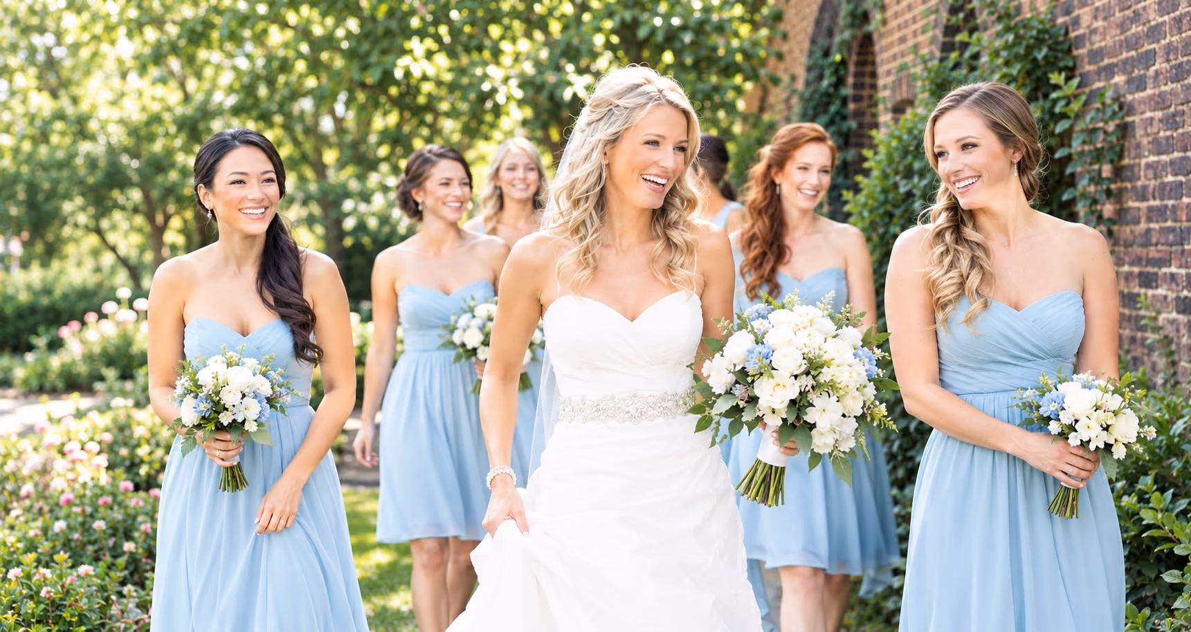 Pretty bride with bridesmaids in light blue