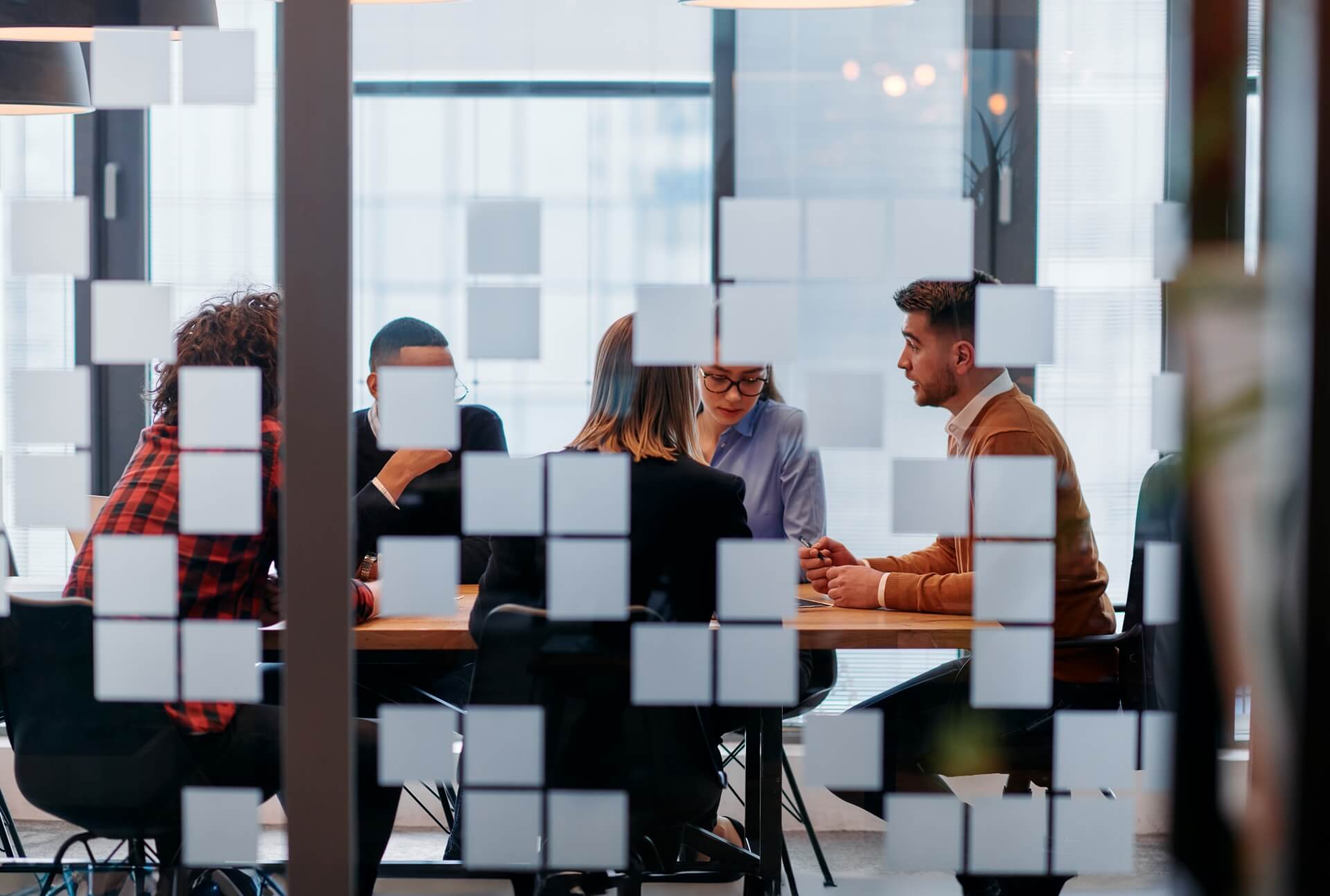 A team in a conference room discussing the question, "does chatgpt generated text hurt your seo?"