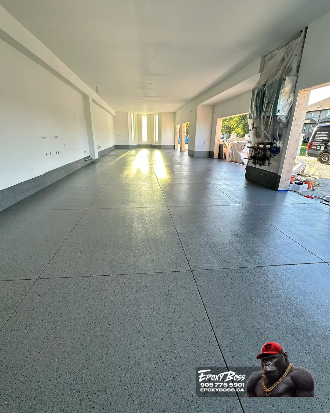 Barrie epoxy Boss crew installing residential garage coating.