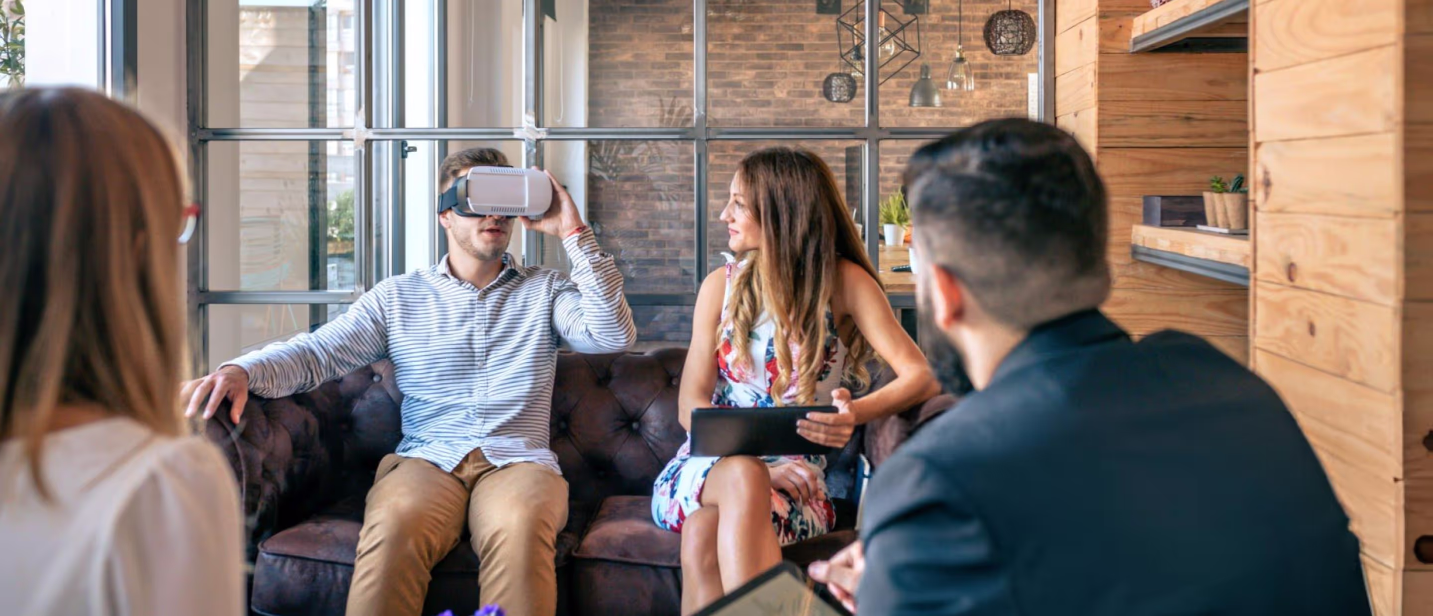 a man trying vr headset in front of other people