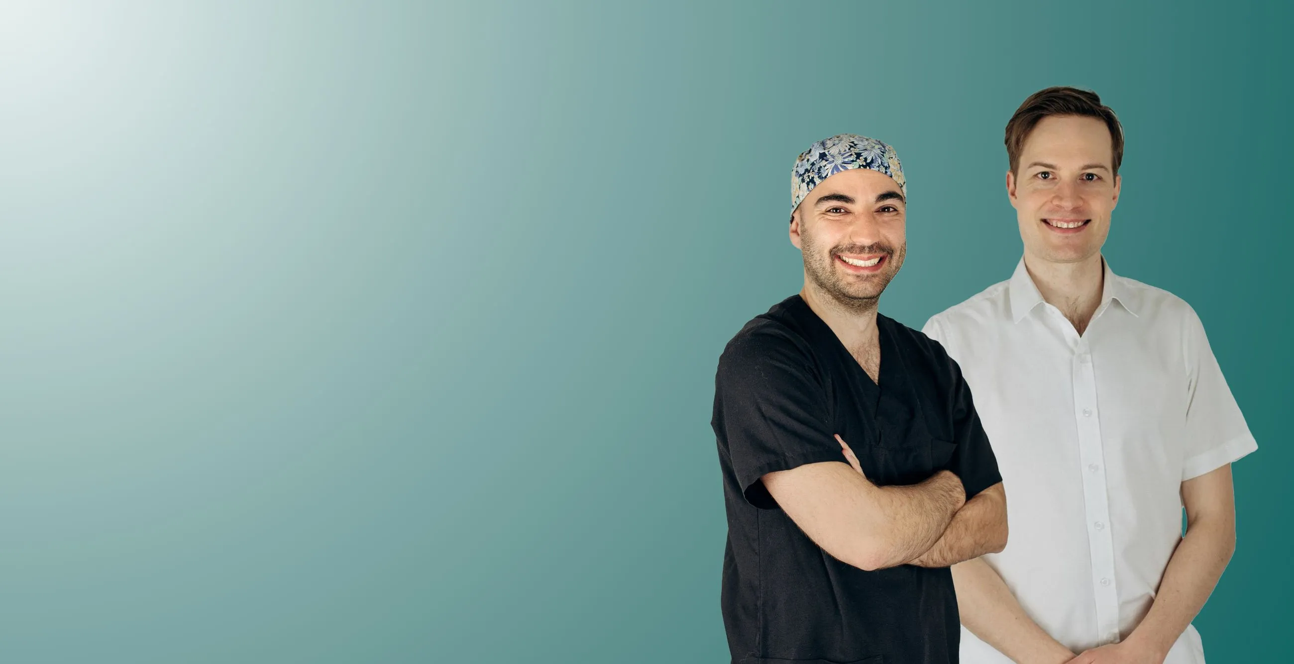 A lady smiling generously in front of a teal background.