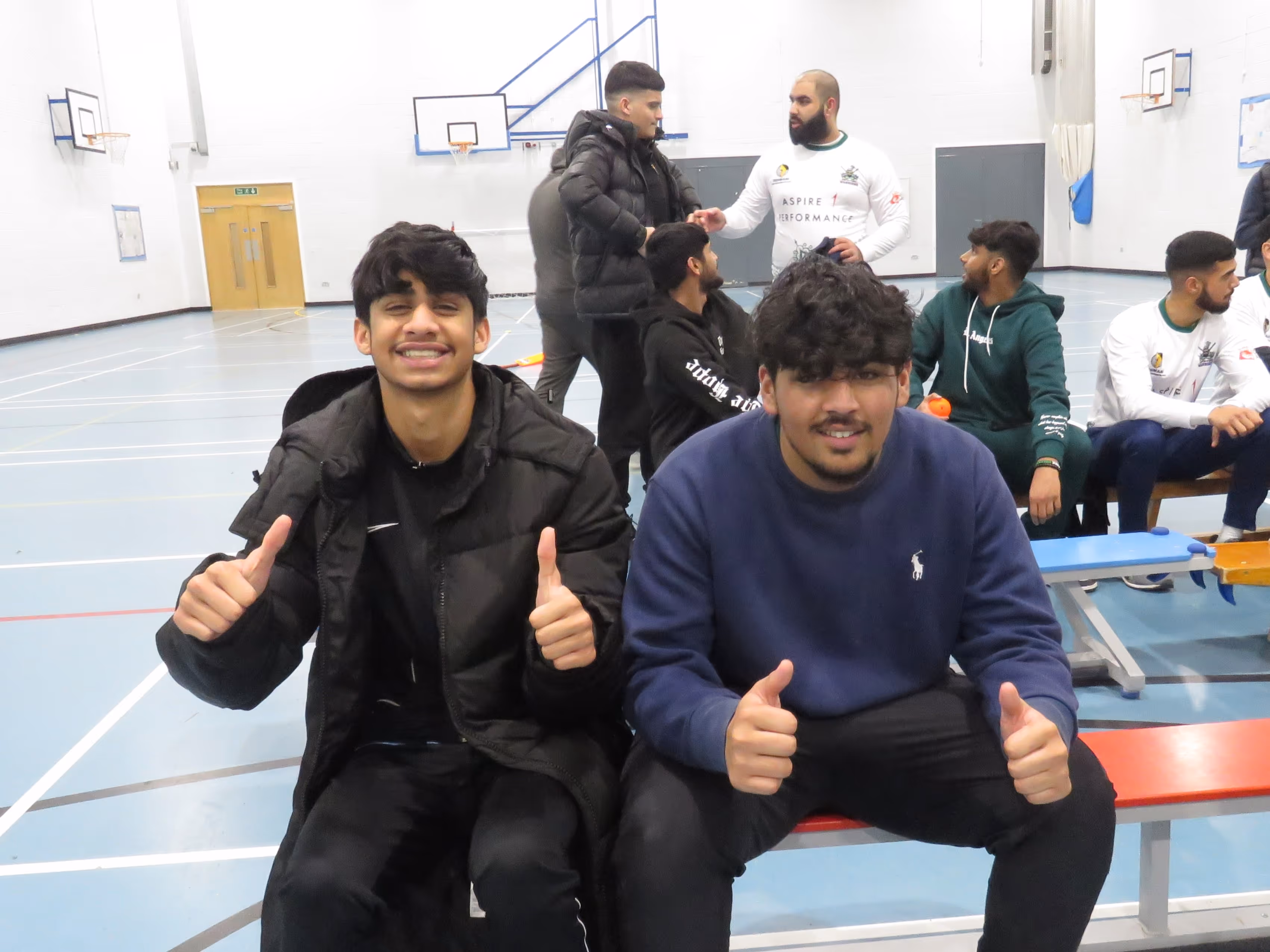 Young players in audience smile and thumbs up to the camera as BBICL presentation ceremony begins