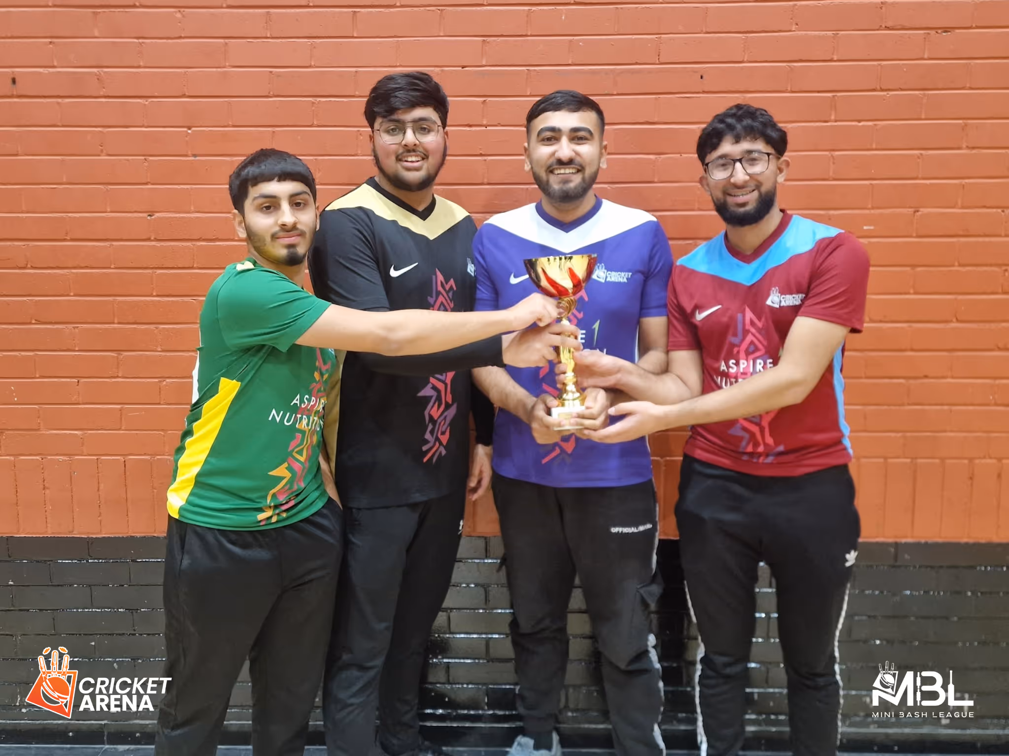 MBL youth indoor 4 semi-finalist captains, wearing their coloured Kits, pose with the MBL trophy