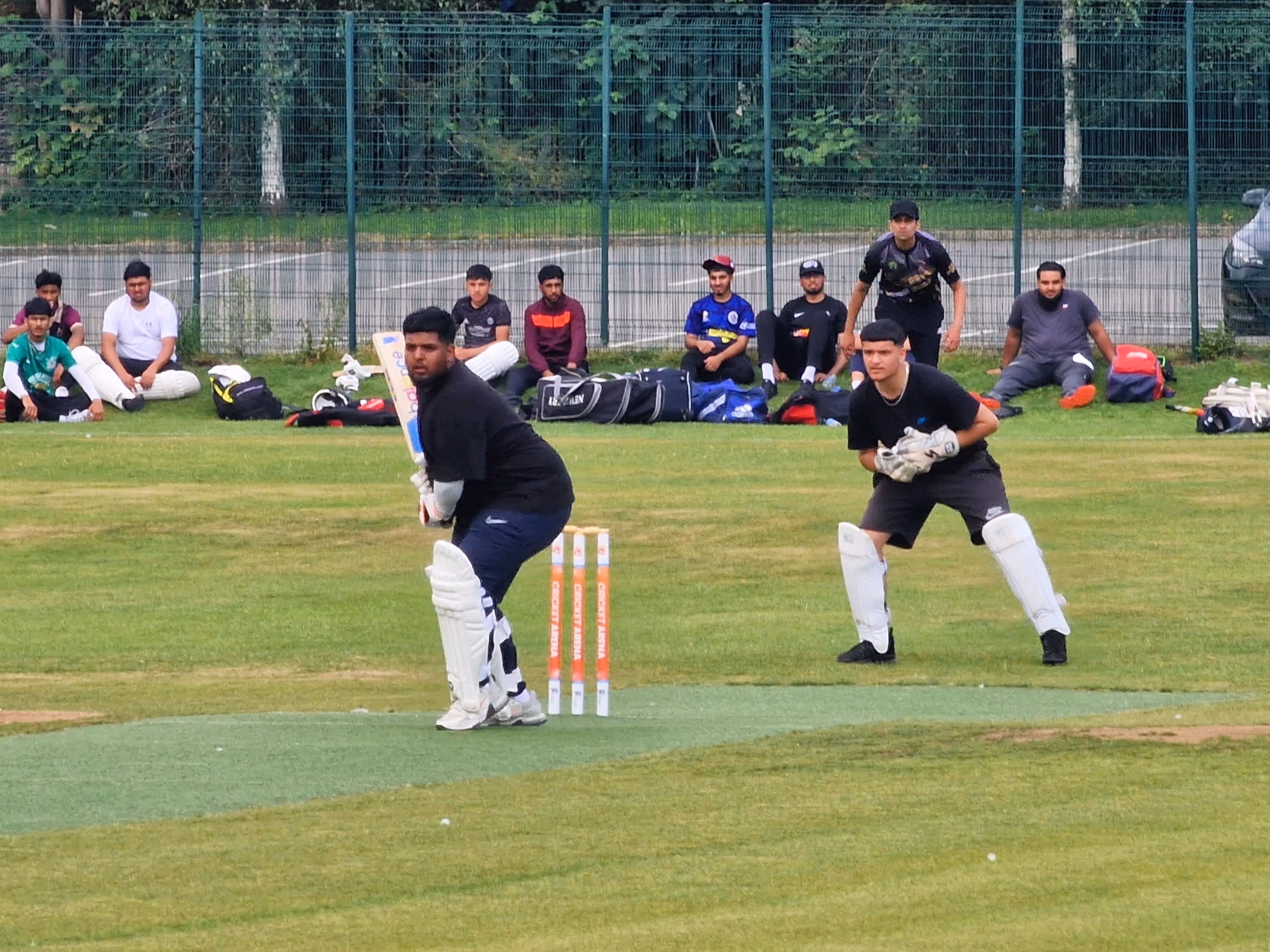 Batsman preparing to face a delivery during the Cricket Arena Youth Hundred match at Shiregreen Cricket Club, with teammates and spectators watching from the sidelines.