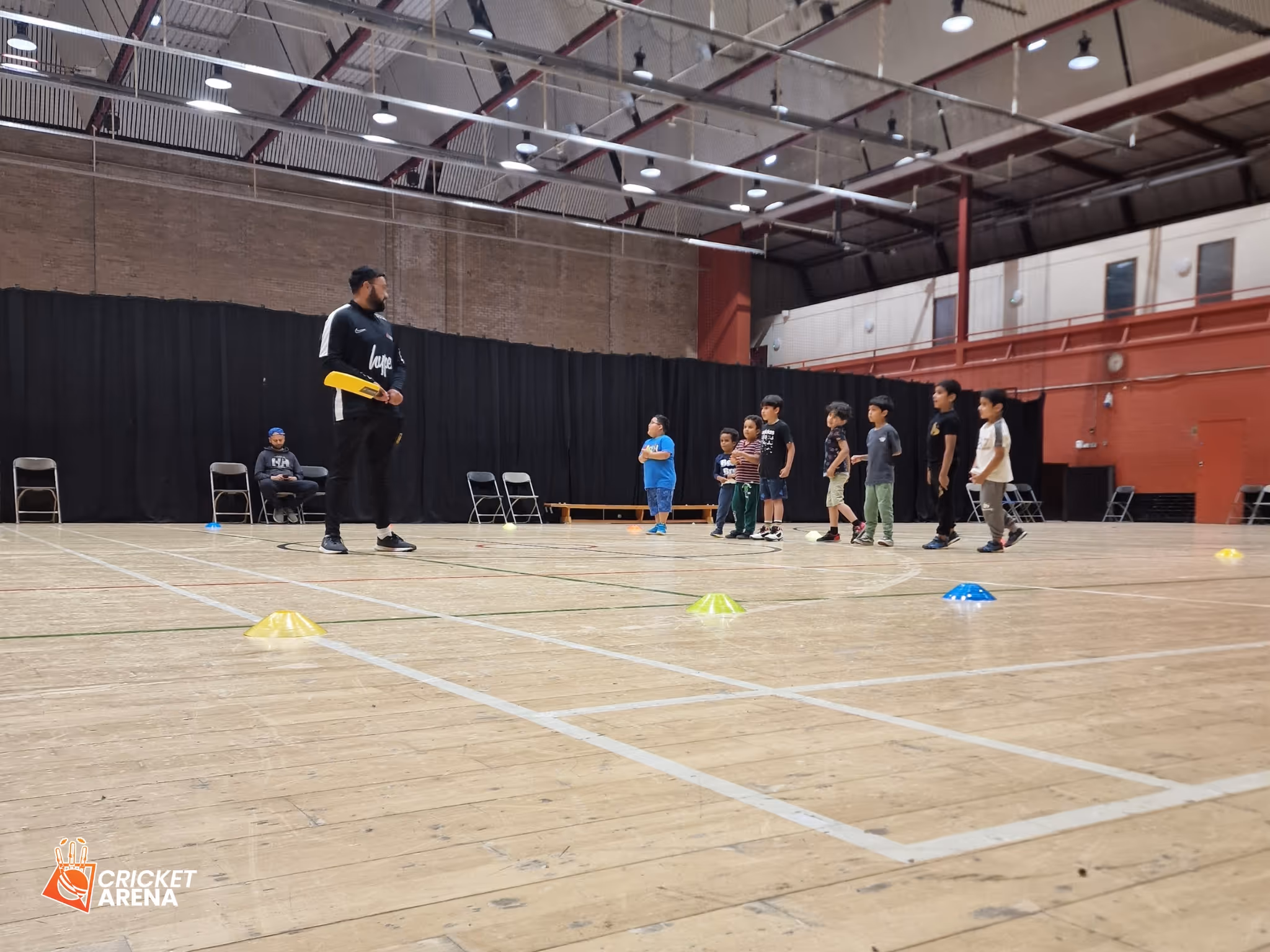 Head ECB coach Jawad Akhtar demonstrating how to hold a cricket bat during an All Stars Cricket session at Concord Sports Centre in Sheffield, organised by Cricket Arena.