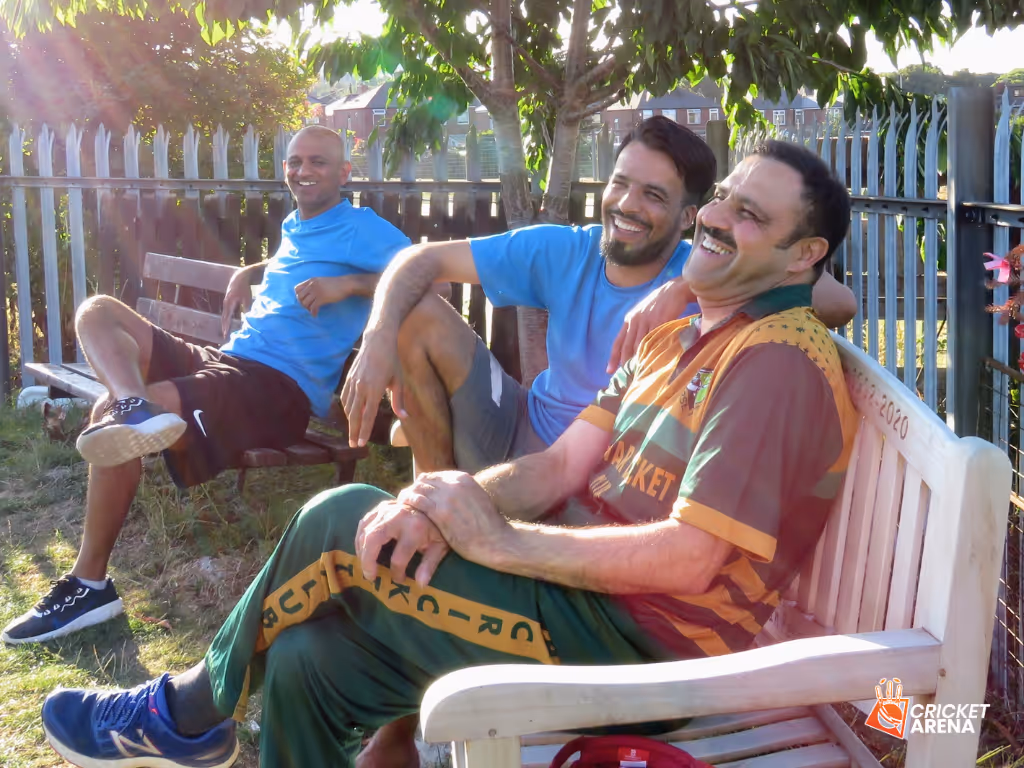 Different generations laugh together on benches while watching Cricket Arena Men’s Hundred match in Sheffield — community cohesion