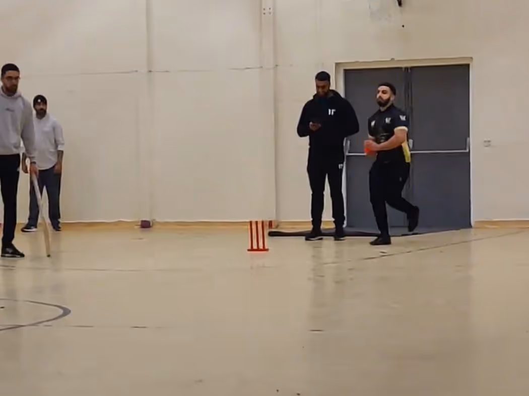 A bowler runs in to deliver beside the signature red Mini Bash League stumps during the Cricket Arena Men’s Mini Bash League 2021 at Yorkshire Muslim Academy (YMA) indoor sports hall in Sheffield.