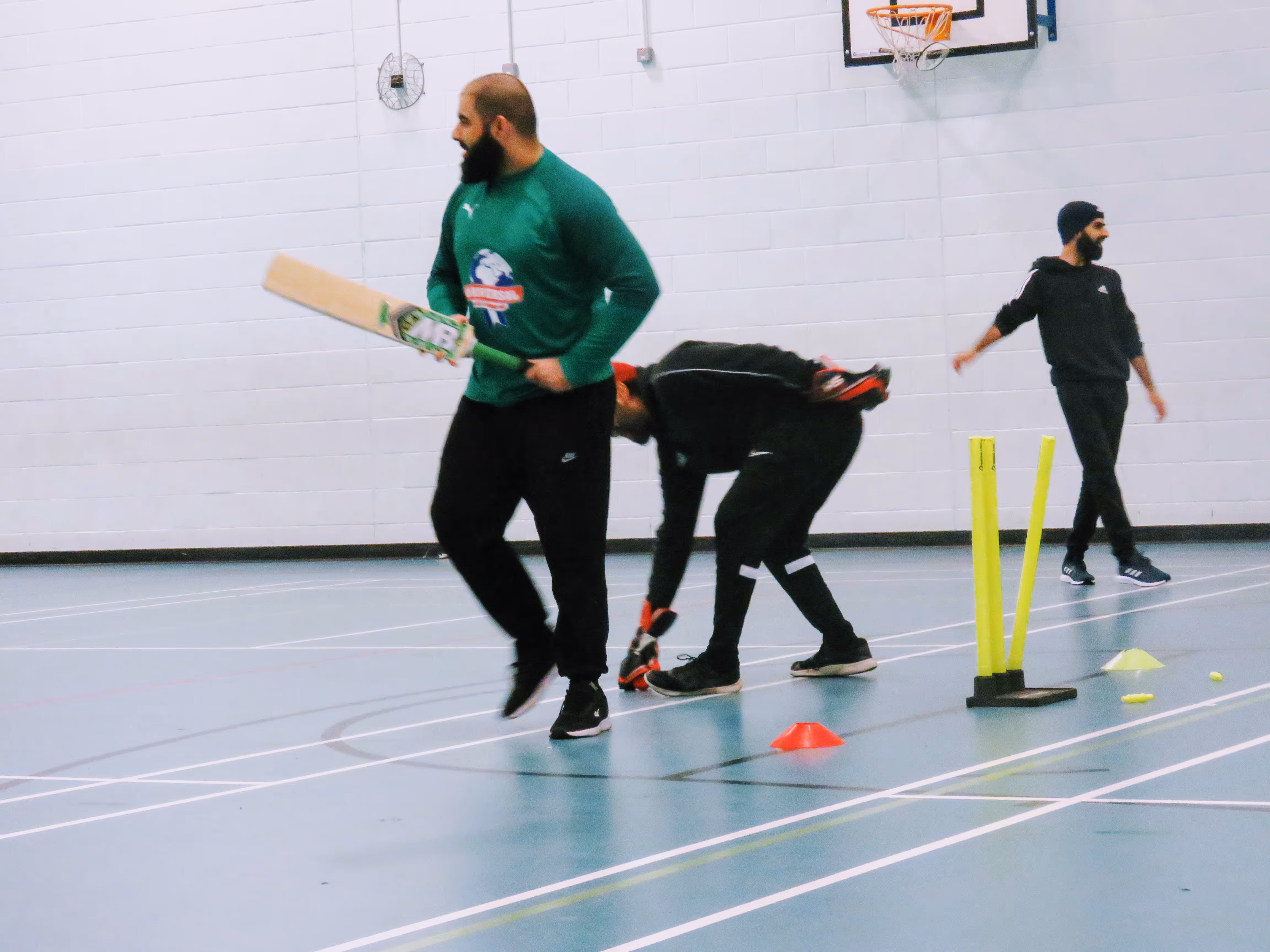 Muhammad Adnan smiles back at bowler Azahat after being bowled during the Sheffield Cup 2022 — a light-hearted moment of friendship and respectful rivalry that defines community cricket.
