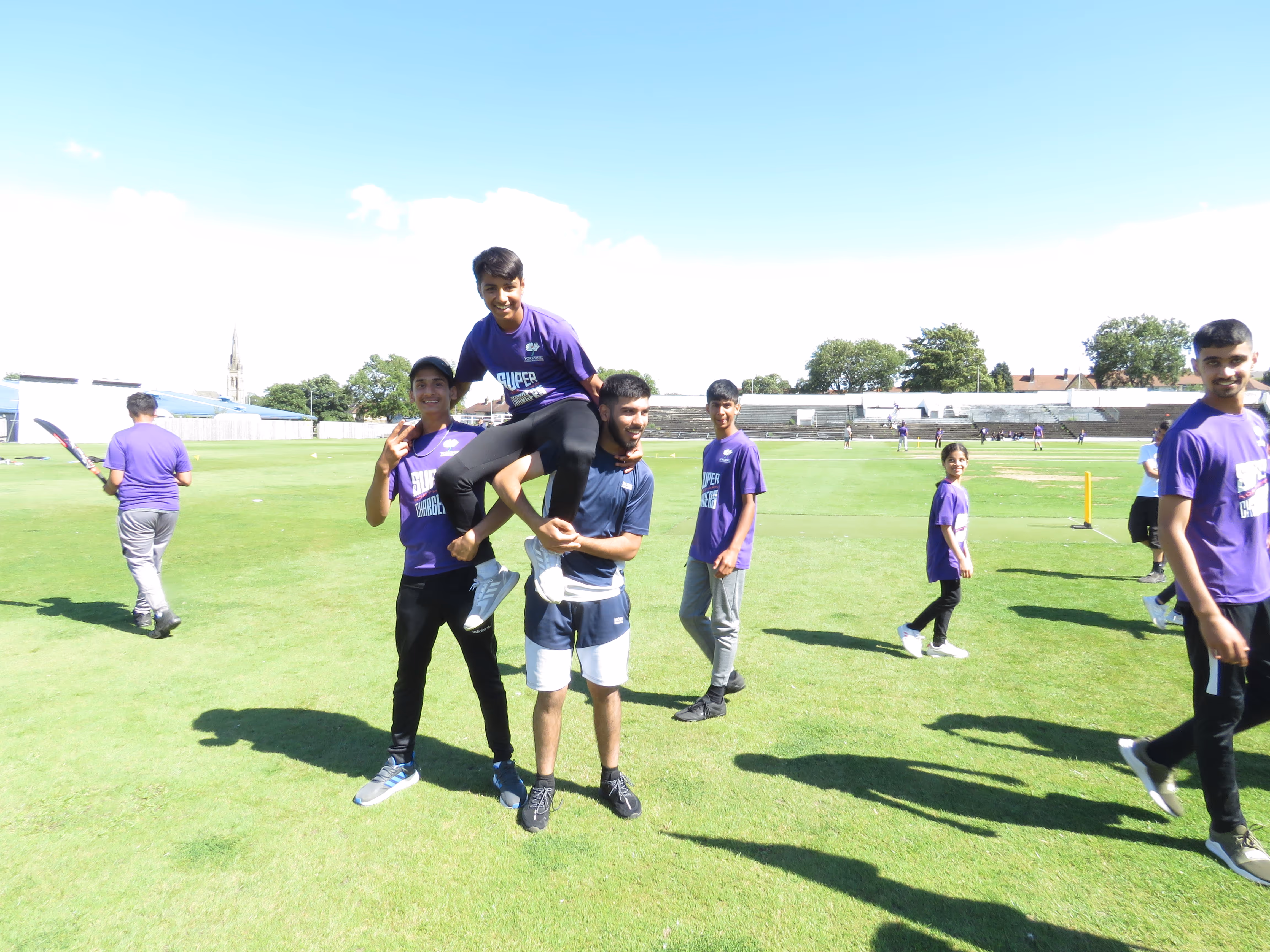Sheffield players celebrate their Junior Hundred 2022 win at Park Avenue by lifting their captain in joy, capturing teamwork, pride and unforgettable memories.