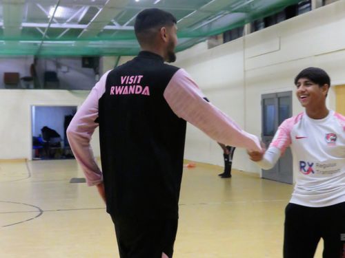 Two players from different teams shake hands smiling before their match showing friendship and networking in cricket
