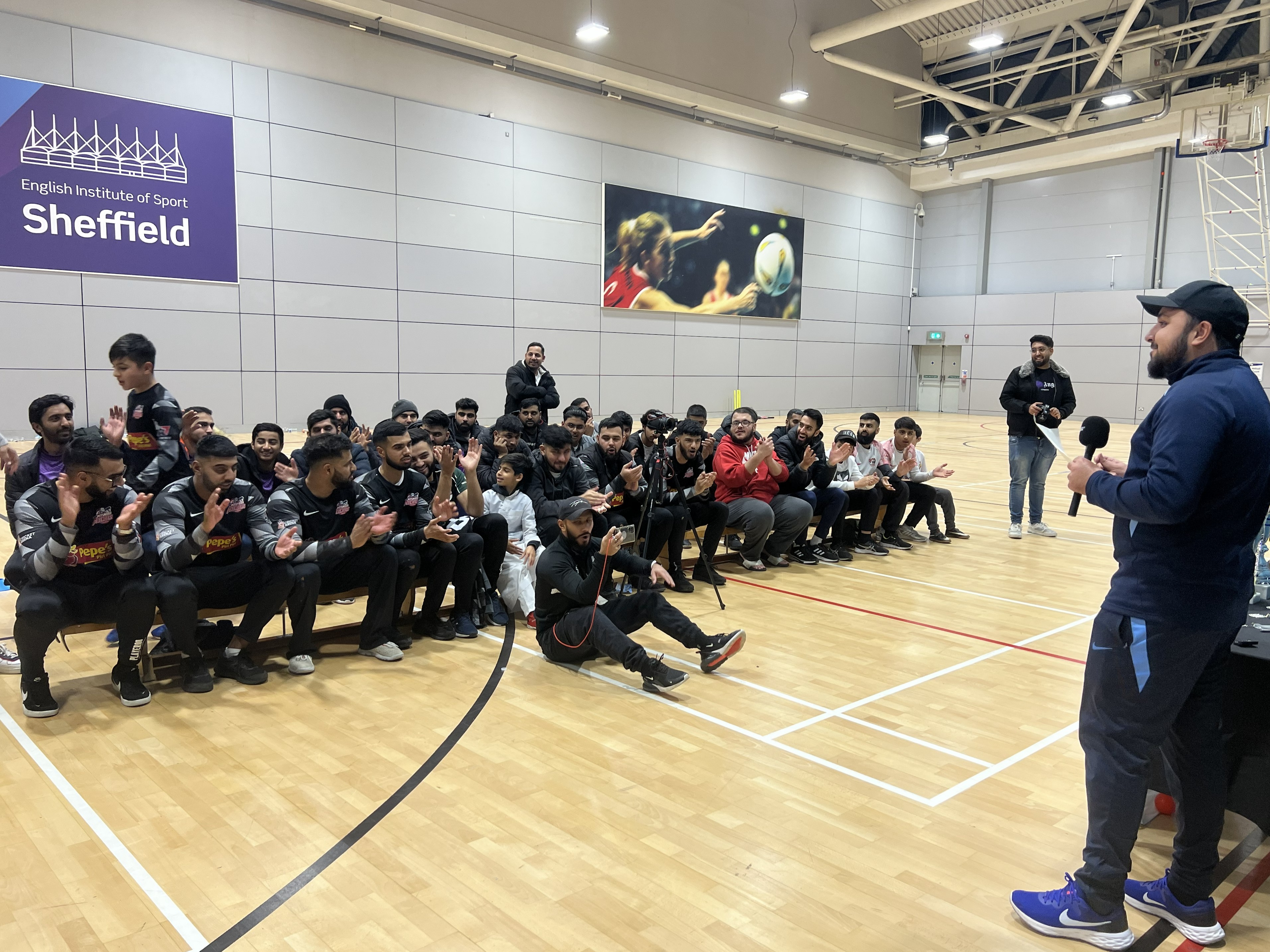 Cricket Arena community applauding a young award winner during the BBICL presentation at EIS Sheffield.