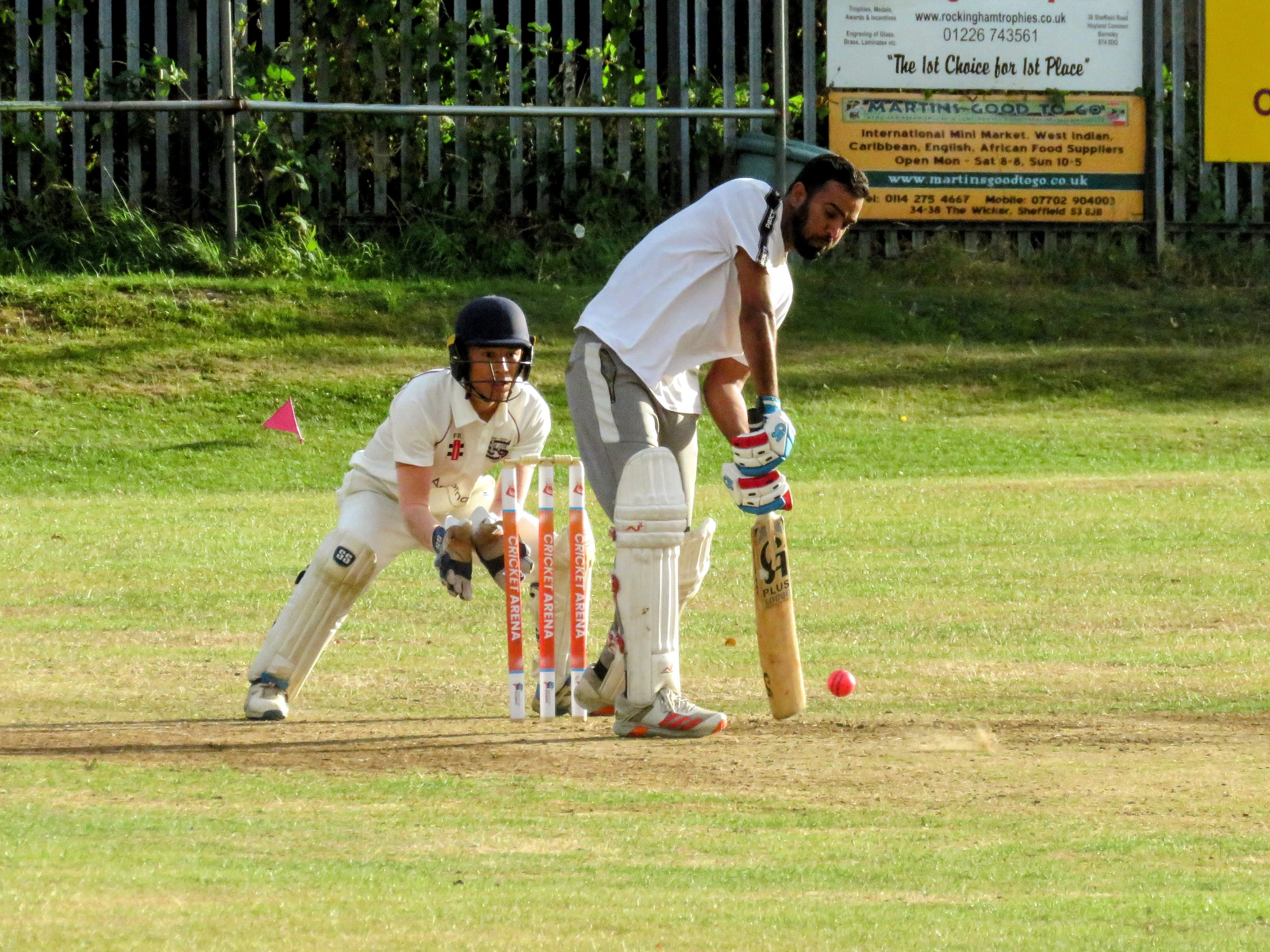 Batter prepares to play a shot with Cricket Arena custom stumps at Caribbean Sports Club, showing diversity and unity