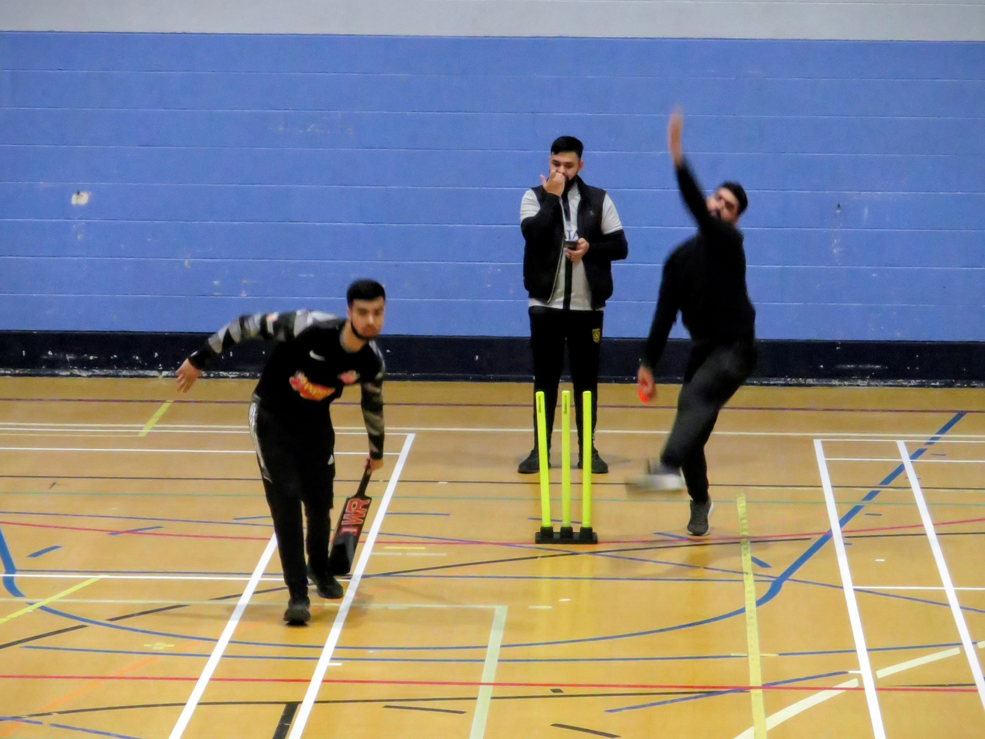 Bowler runs in to deliver as the batsman backs up during an indoor cricket match at Hillsborough Leisure Centre in Sheffield.