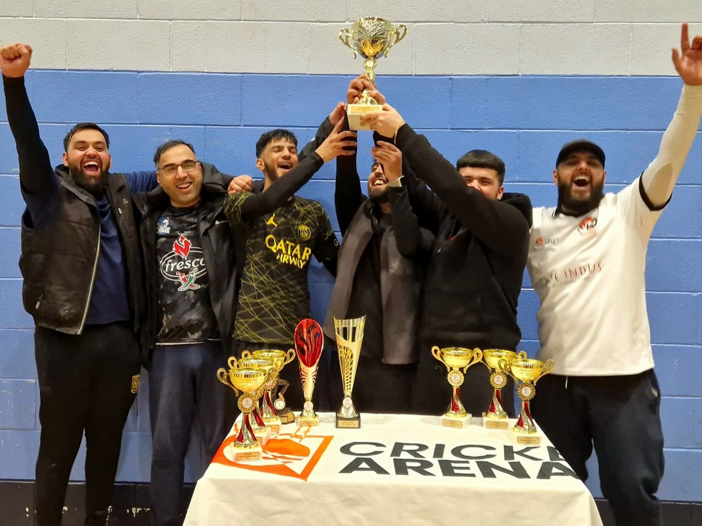 Sheffield Cup 2023 champions lifting the winning trophy high and celebrating together after their Cricket Arena victory.
