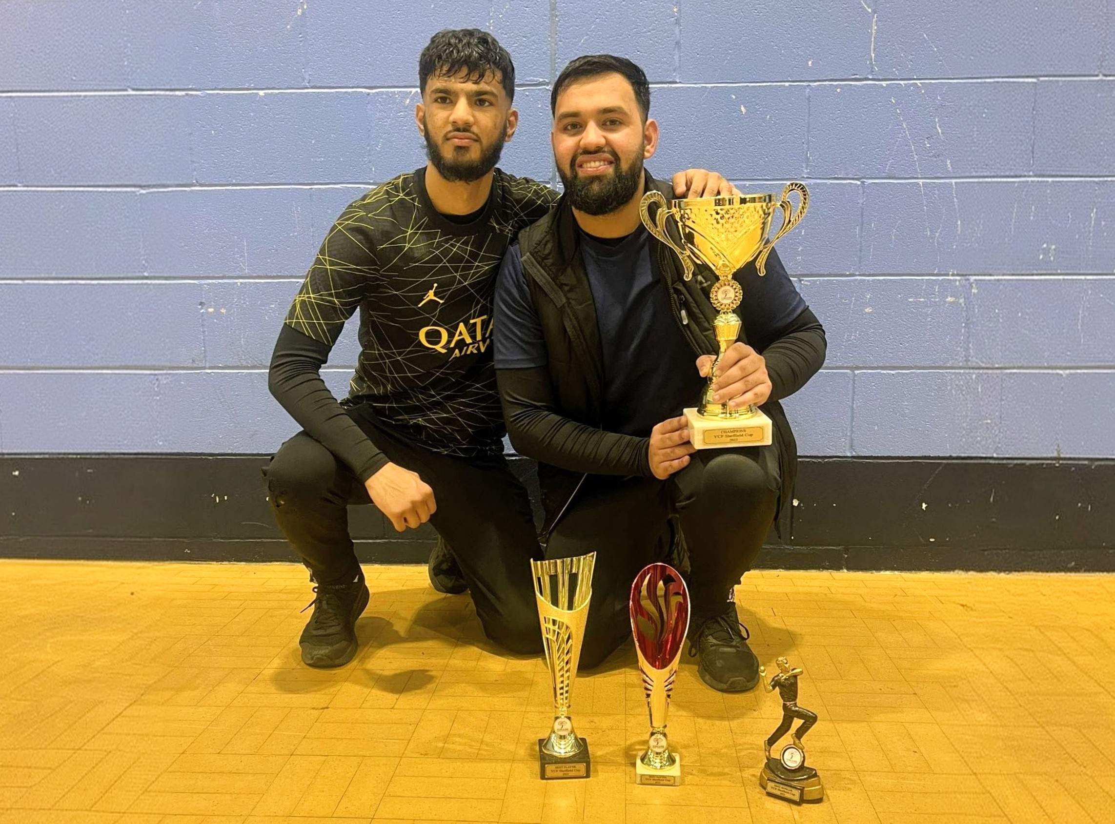 MVP and winning teammate proudly holding trophies and awards after the Cricket Arena Sheffield Cup 2023 presentation.