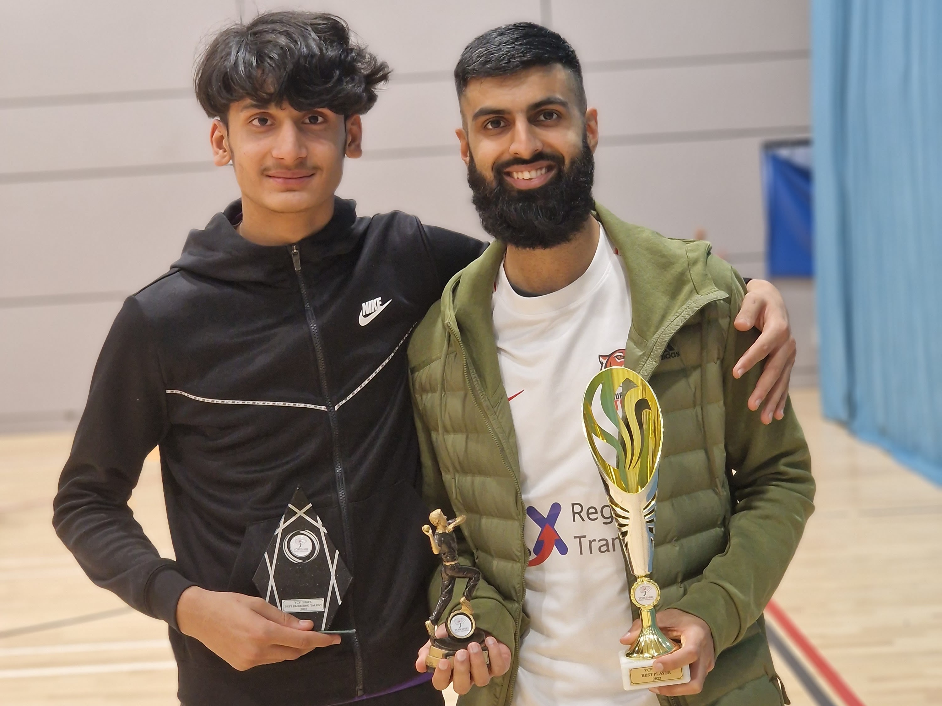 Youngster Fasih Khan and Sid pose together after the BBICL presentation ceremony, proudly holding their trophies for Best Emerging Talent and Most Valuable Player. A moment of humility and joy celebrating bright young cricketing talent.