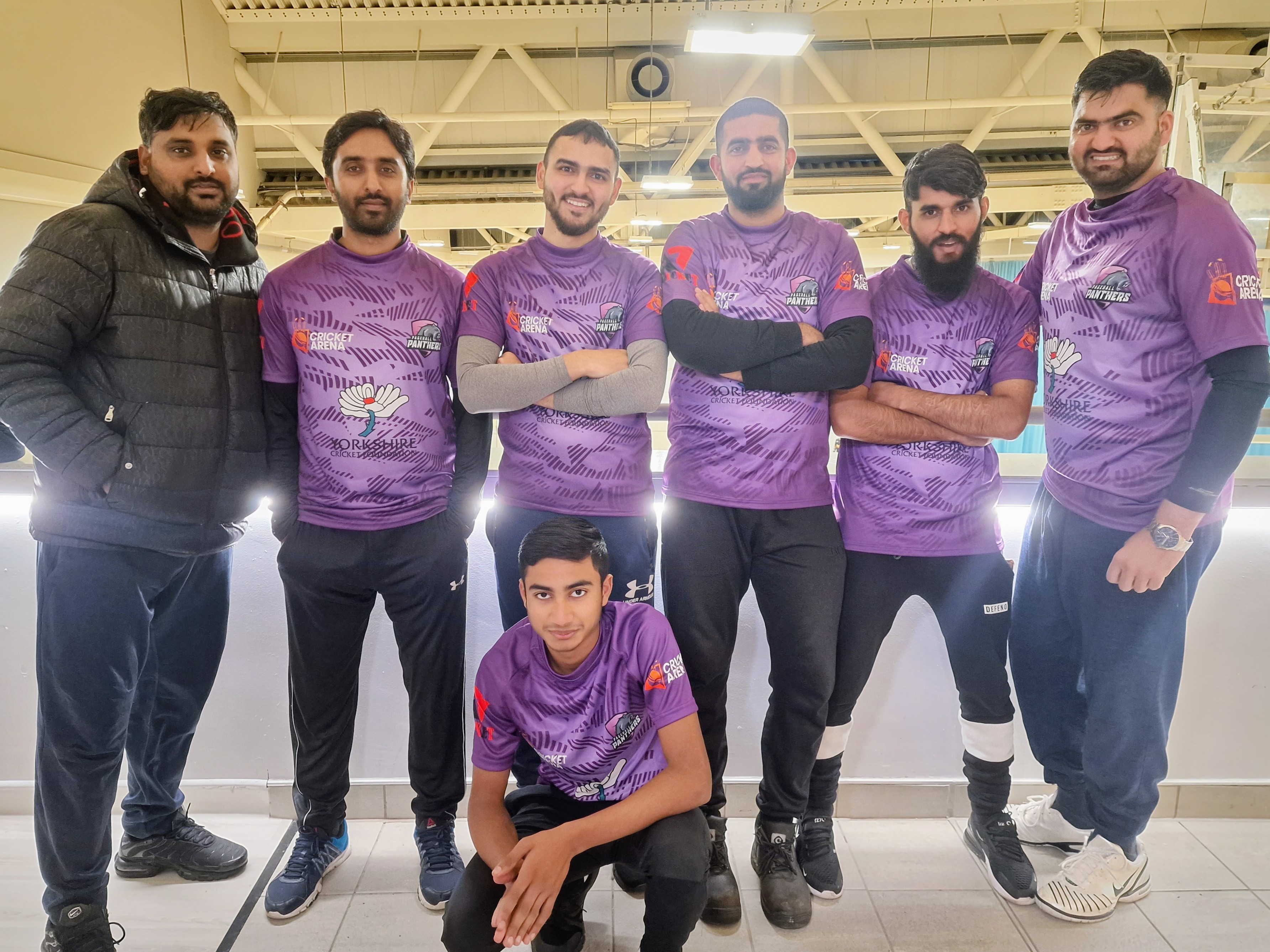Team Pagehall Panthers pose together on the EIS balcony in their purple Yorkshire Cricket Foundation kits, showing unity and pride as part of the BBICL league.