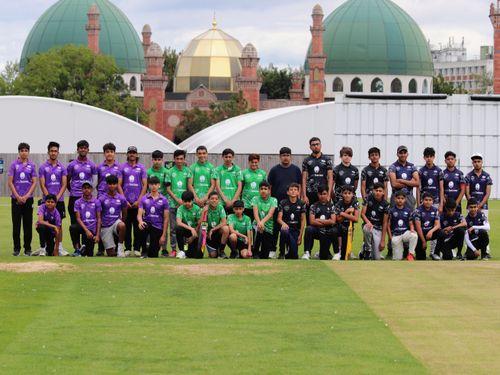 All four teams from the Yorkshire Junior Hundred 2023 pose together at Park Avenue, Bradford, with the mosque domes in the background — players in purple, green, and black kits representing different regions including Sheffield.