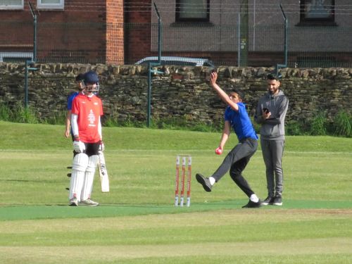 Zaheer bowls with a pink hardball as the umpire watches during the Cricket Arena Youth Hundred at Shiregreen.