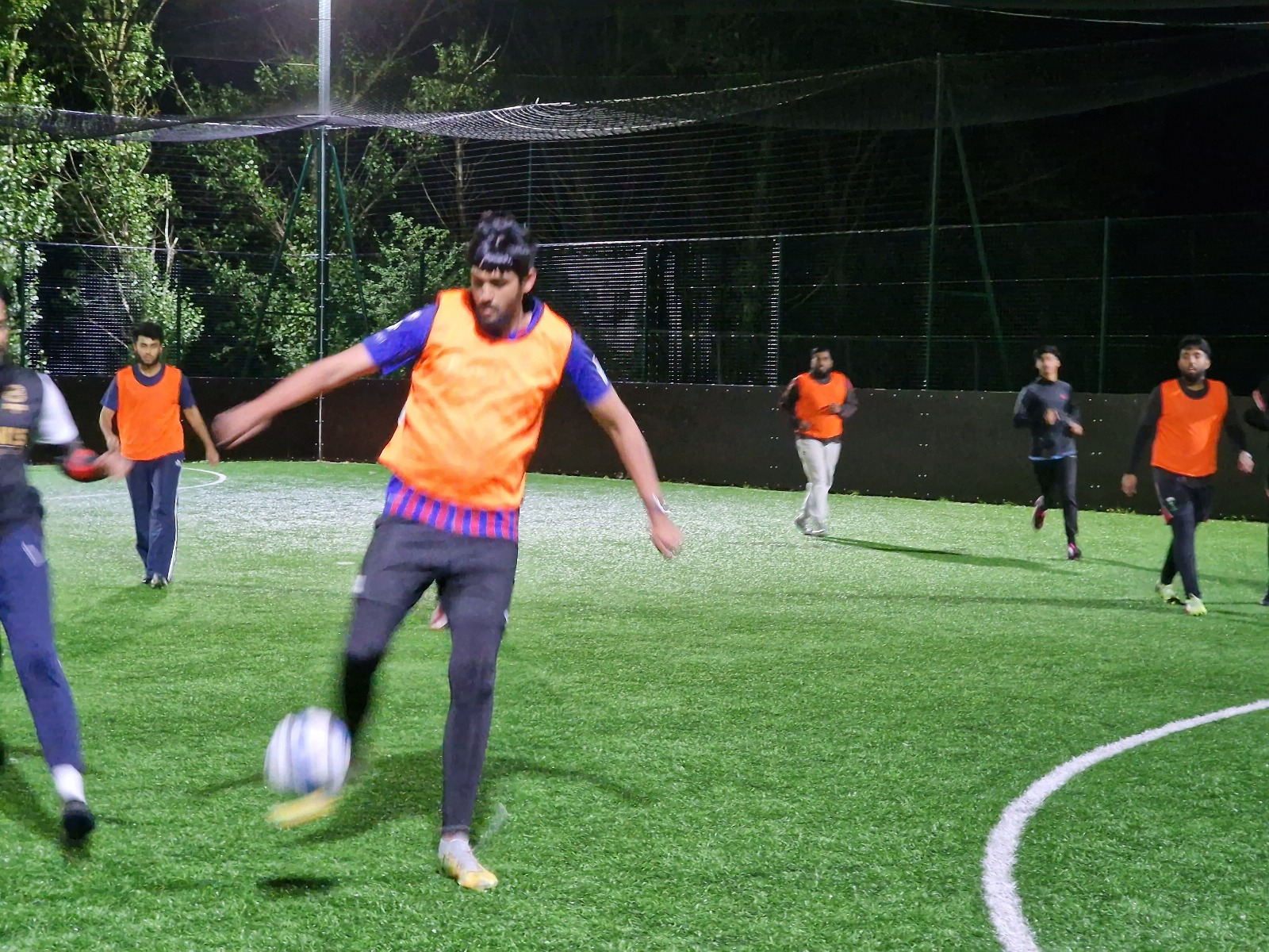 Coach Muhammad Amjad joins young players in a football match at Davy Sports Club Sheffield during Barclays Community Football Fund project