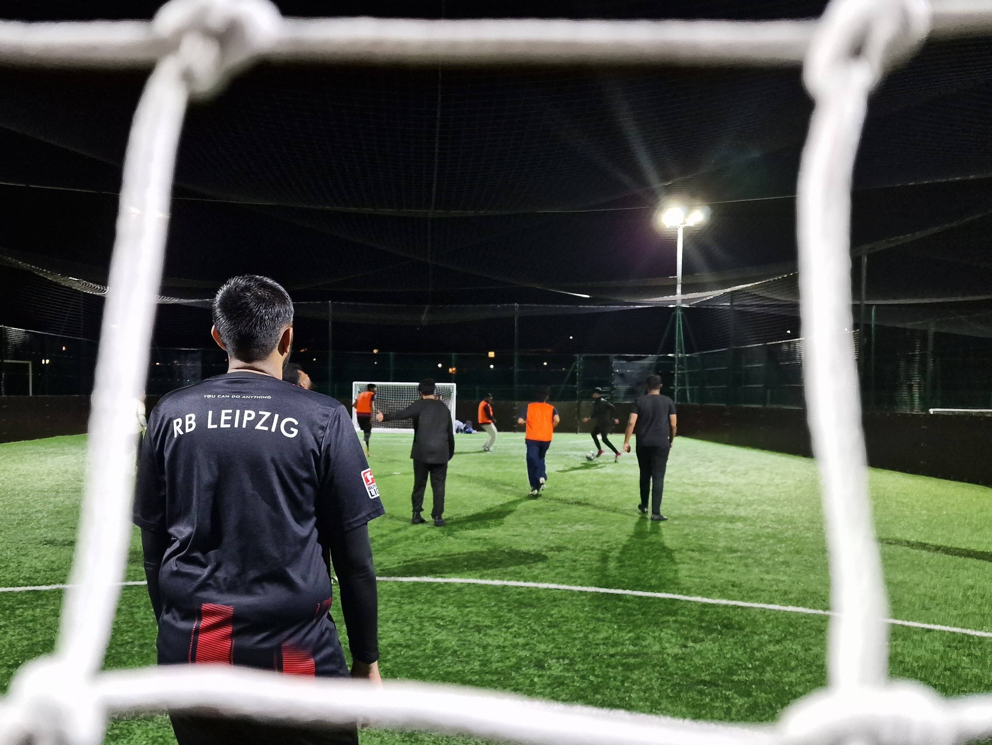 View through the goal net as goalkeeper watches community football action at Davy Sports Club Sheffield during Barclays Community Football Fund project