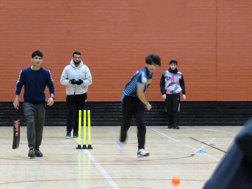 A left-arm bowler delivers pace during MBL 2023 at Concord Sports Centre, Sheffield, showcasing youth indoor windball cricket.