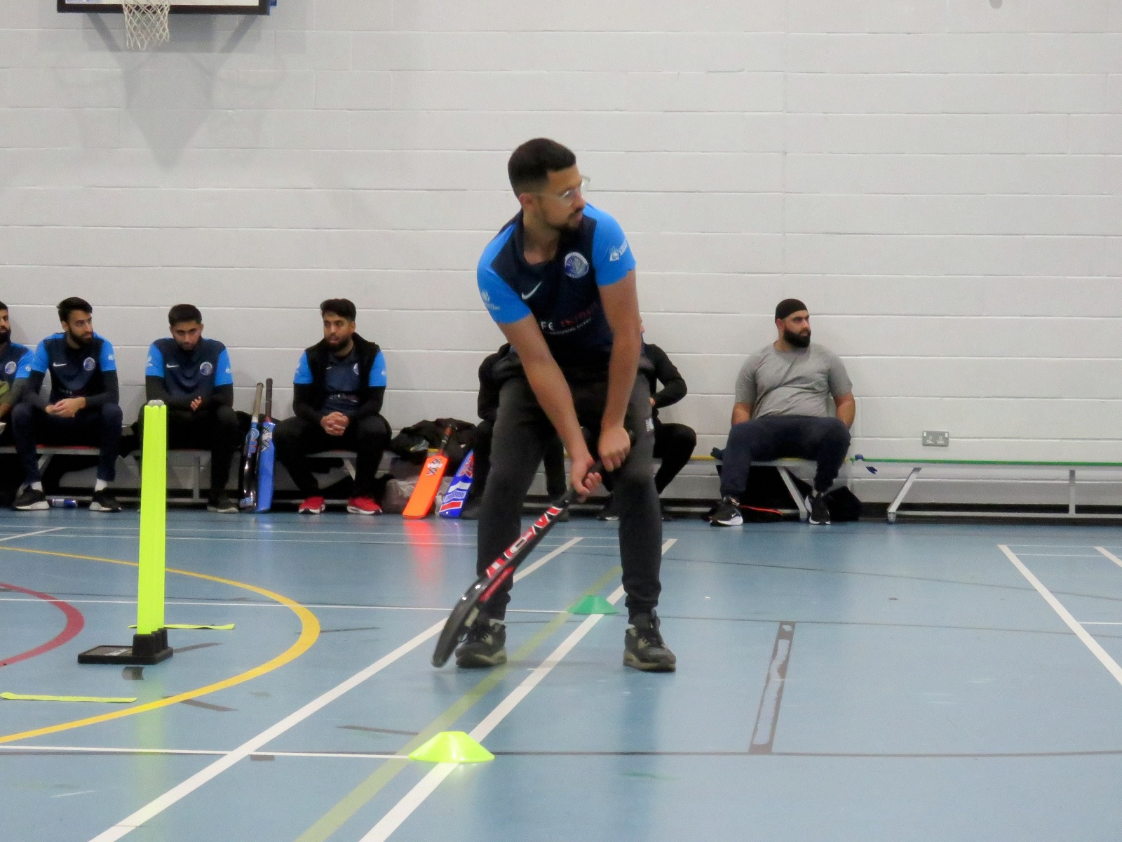 Hamzah sets to strike in Netheredge Knights kit—confidence and intent; Cafe Indus sponsor visible at Sheffield Park Academy.