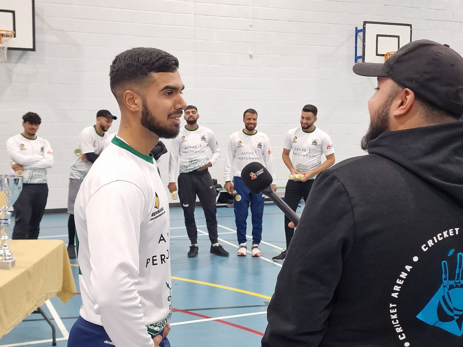Winning captain Shohaib is interviewed post-final as teammates smile in support—team pride at Sheffield Park Academy.