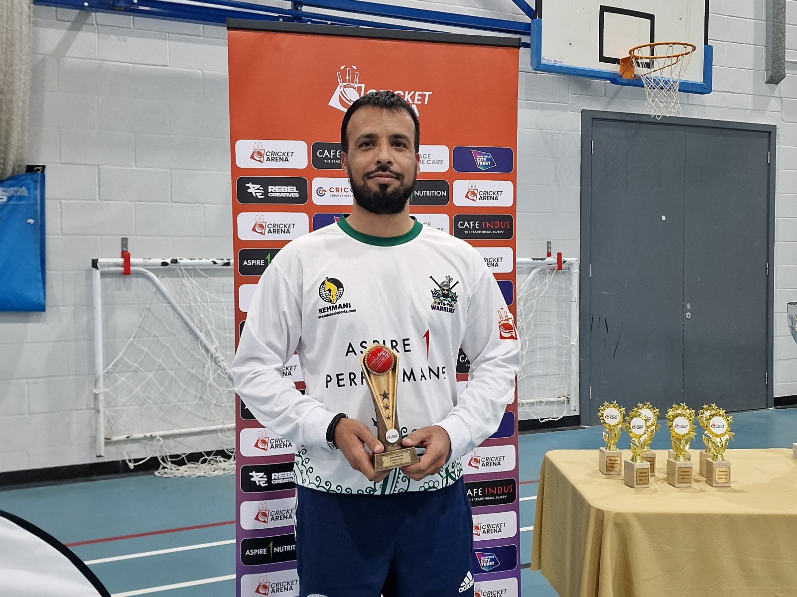 Asif Muhmand holds the Best Bowler award—leading wicket-taker recognised at the BBICL 2023 presentation in Sheffield.