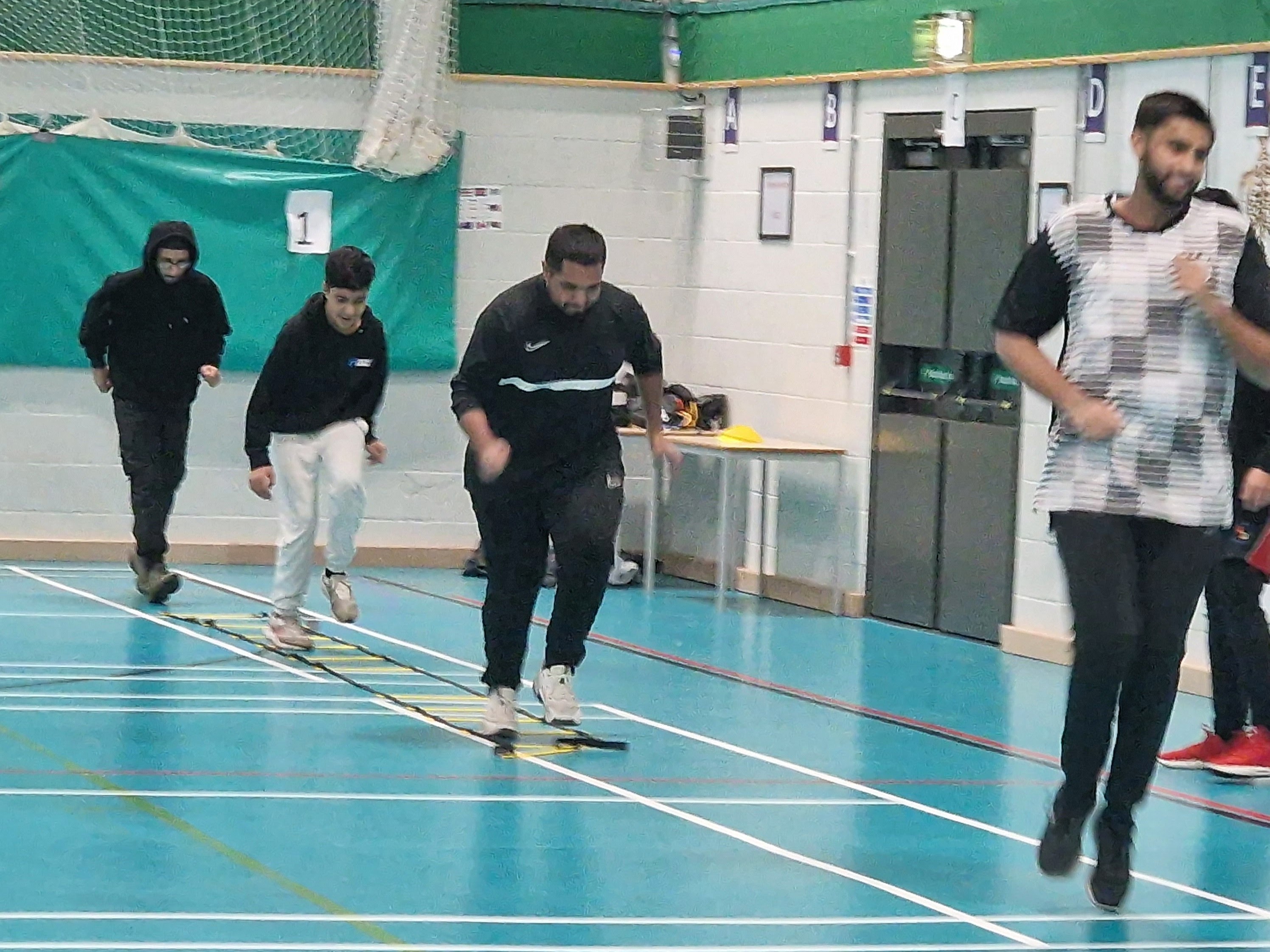 Boys 13–17 run an agility-ladder drill in the sports hall at Astrea Academy, Sheffield.