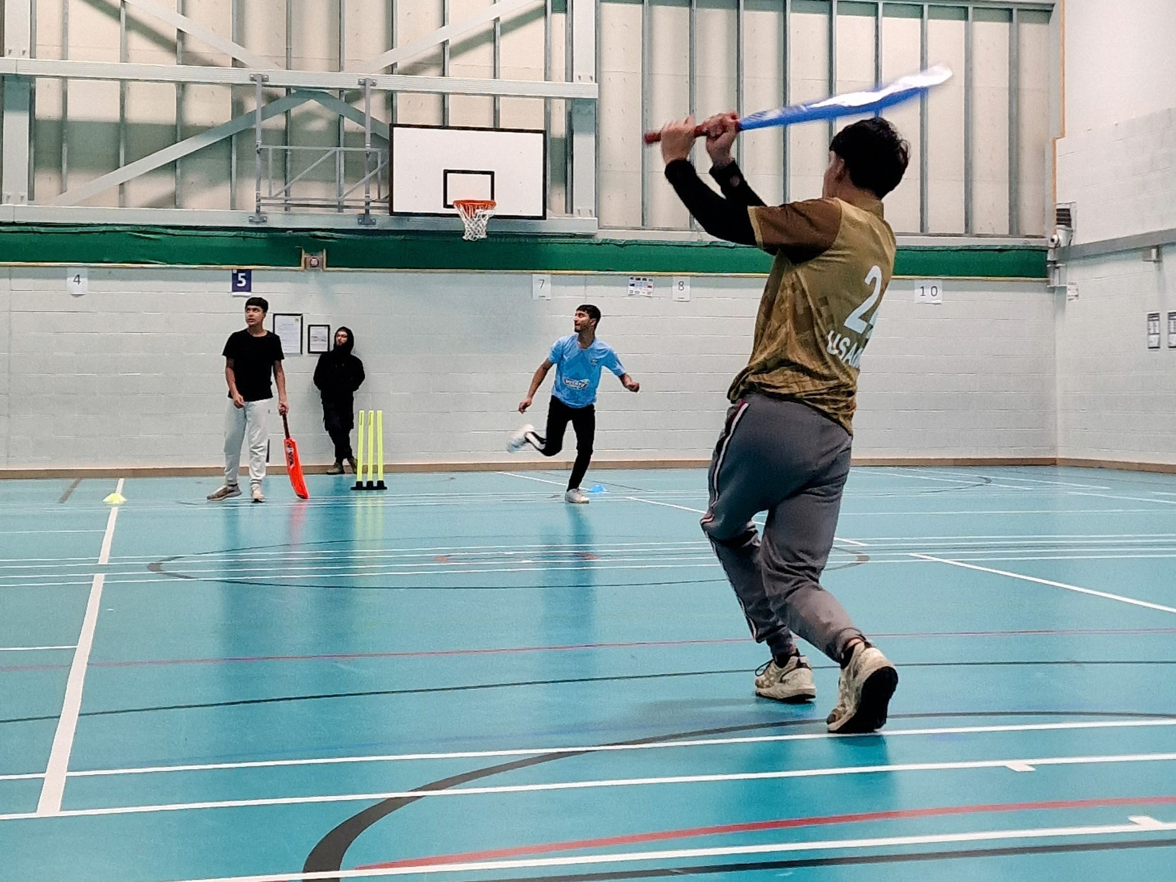 Batter swings through a soft-ball cricket shot in the sports hall at Astrea Academy, Sheffield.