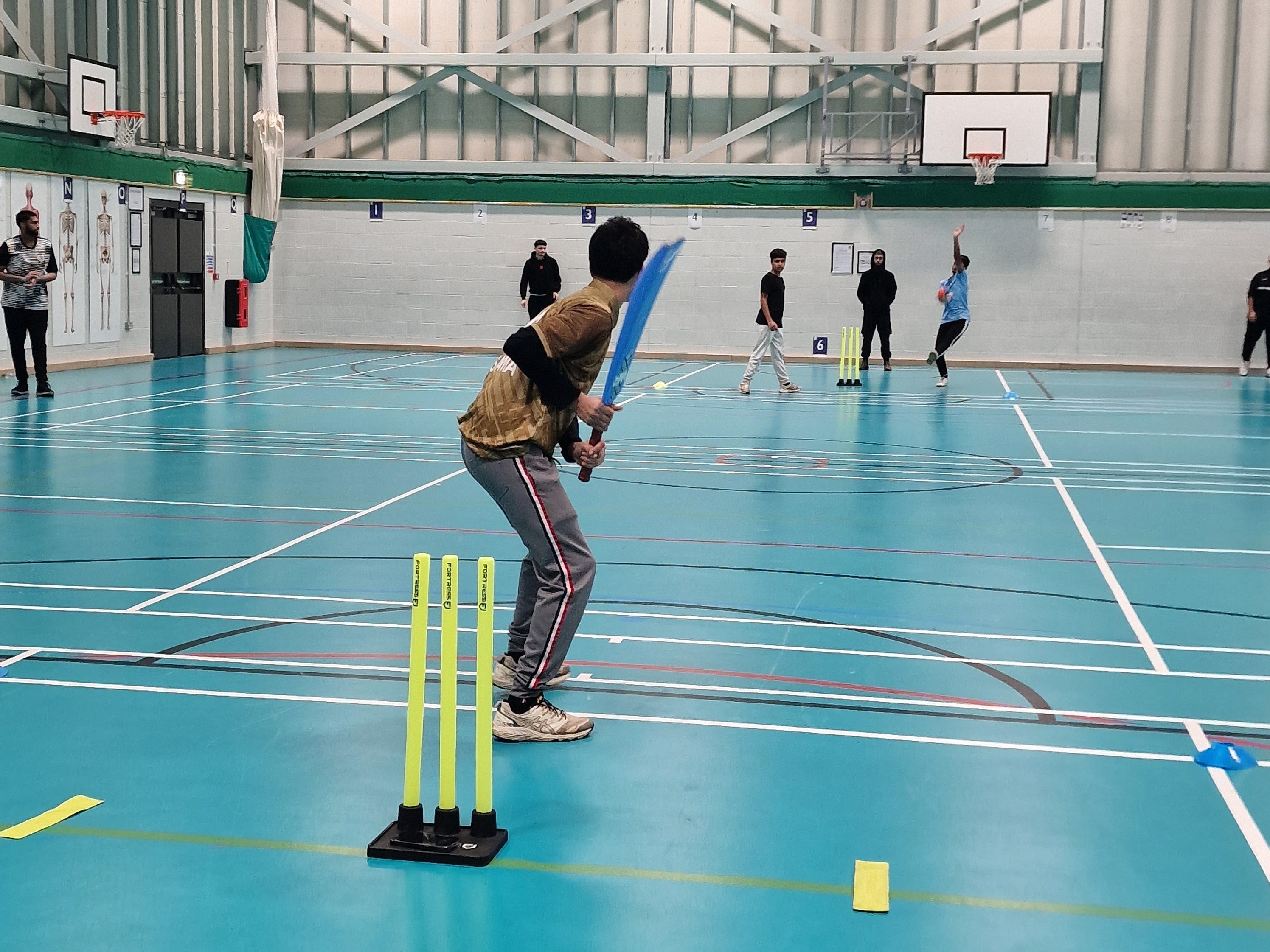 Teen batter sets up for a soft-ball delivery during indoor cricket at Astrea Academy, Sheffield.